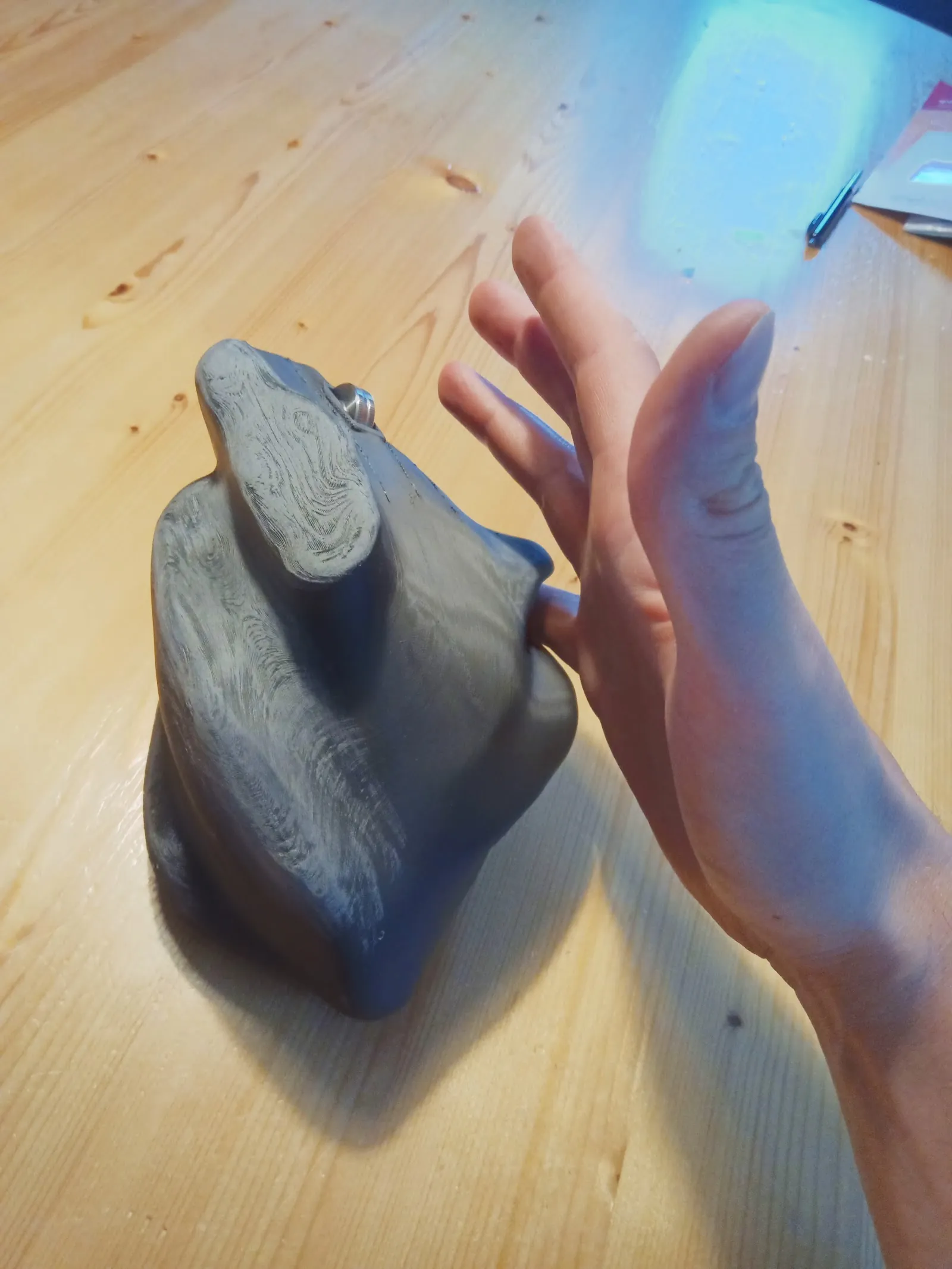 The finished tailor made mouse held in the hand it was shaped for